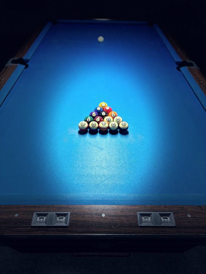 Racked billiards table with blue felt at End Pocket pool hall in Hamilton